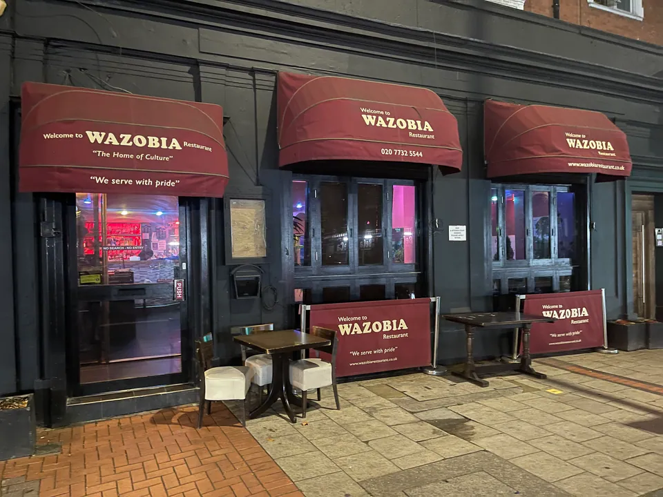 The Wazobia frontage with awnings and outdoor tables