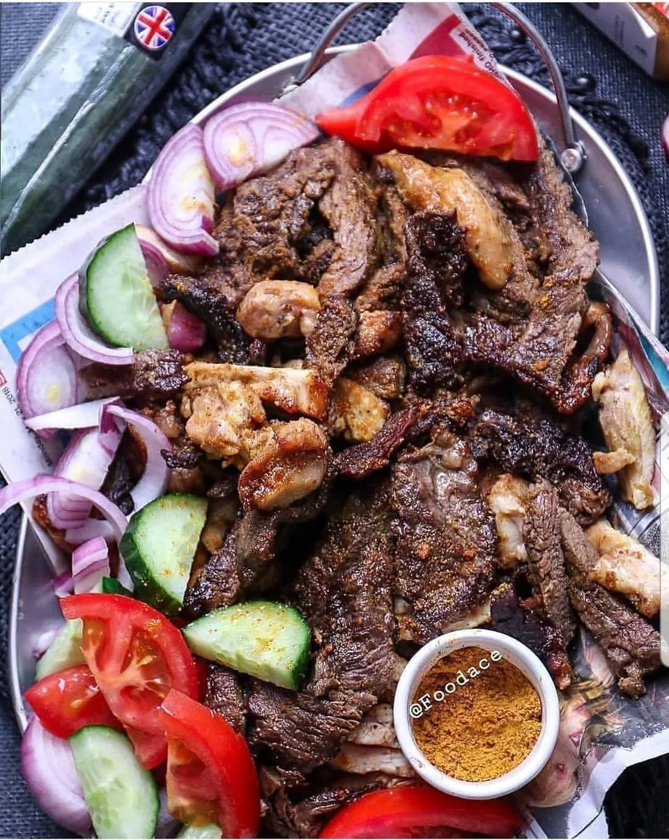 A grilled meat platter with fresh garnishes